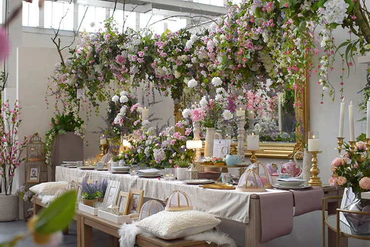 pastel colour bridgerton-inspired faux flower tea party decorations on long table
